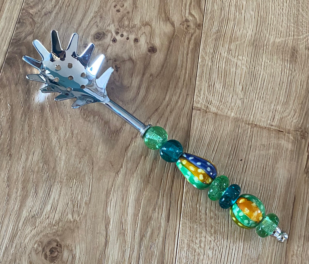 Pasta serving spoon with beaded or ceramic handle