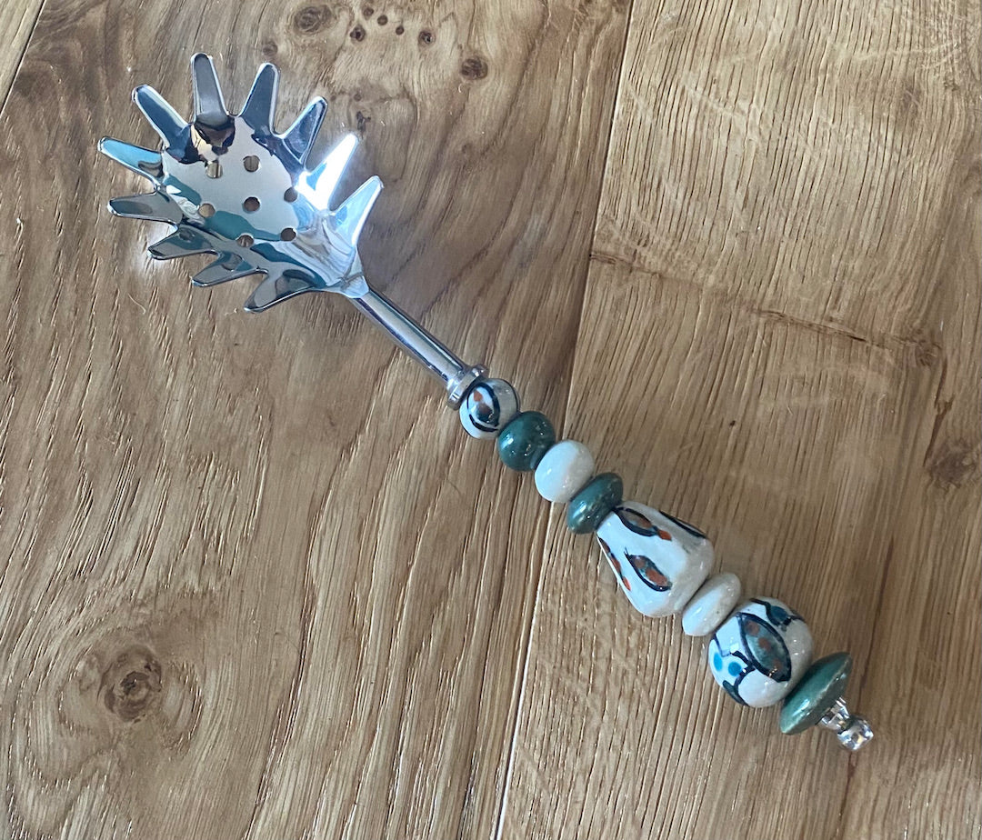 Pasta serving spoon with beaded or ceramic handle