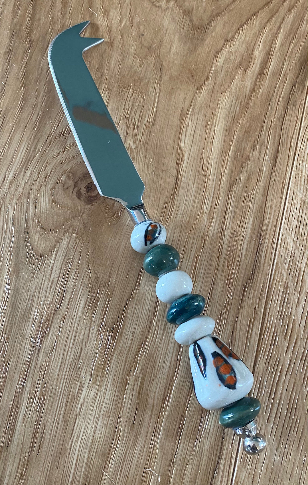 Cheese knife with beaded or ceramic handle